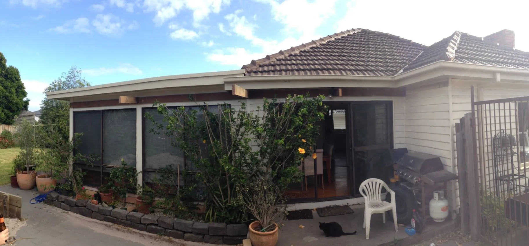 Existing Bentleigh East home viewed from the rear garden and paved outdoor area